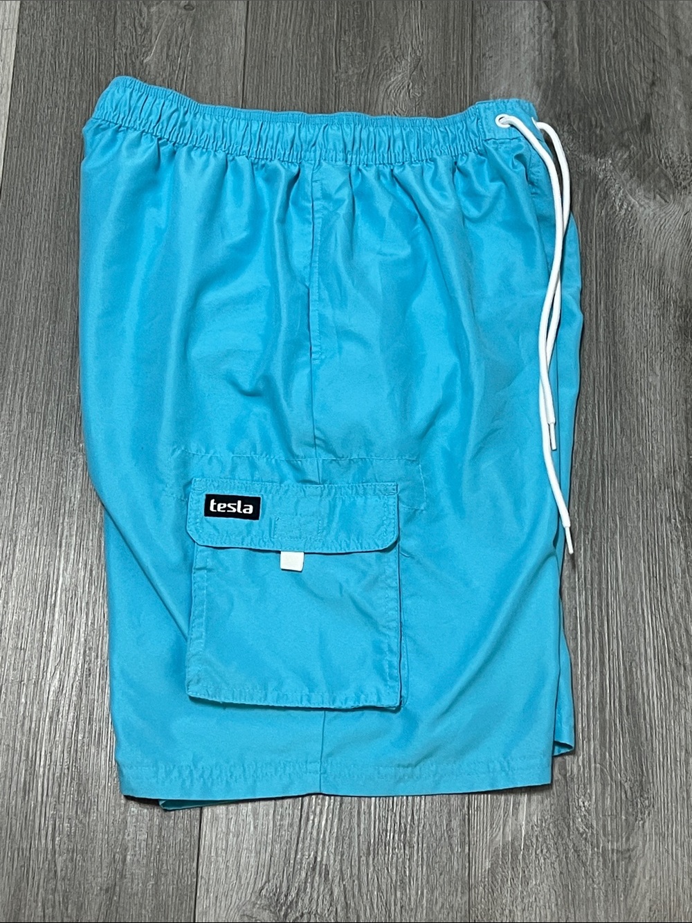 Tesla Mens turquoise swim trunks / size M